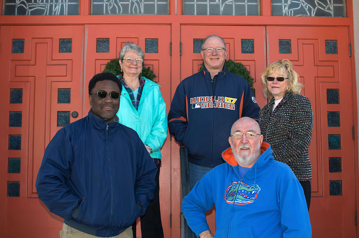 Marcus Dixon, left, director of the Multicultural Resource Center, works with church historians, Len McClenny, right, and, in back row from left, Joan McClenny, interim Pastor Jeff Brinkman and Kathy Kruger