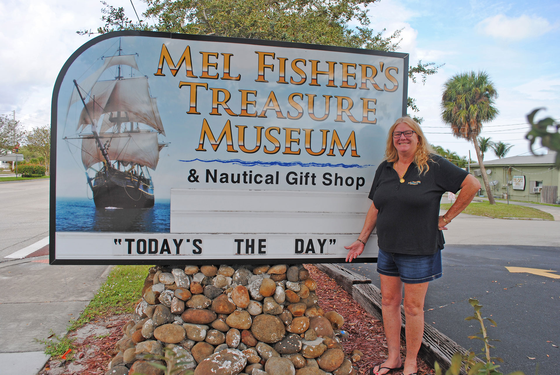 Taffi Fisher Abt, a partner in the family salvage business, had her father’s motto added to the sign outside of Mel Fisher’s Treasure Museum and Gift Shop. KERRY FIRTH PHOTO