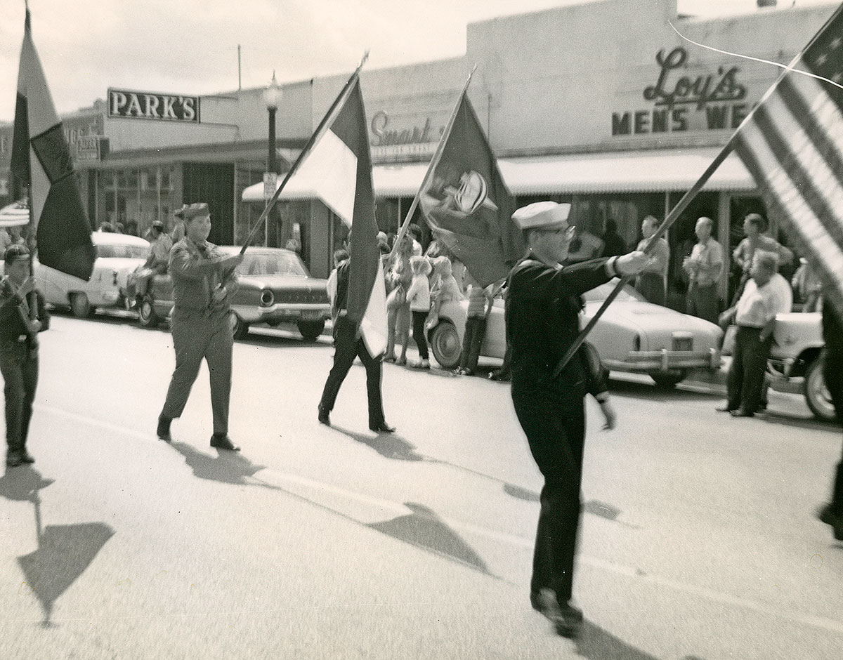 patriotic unit marches in front of Loy’s Men’s Wear in Vero Beach