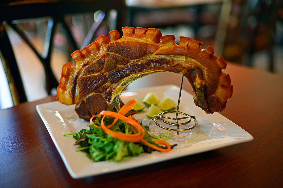 Unique to Puerto Rican cuisine, the pork kan-kan is a magnificent display of a double-loin pork chop with pork belly, rib meat and chicharrones.