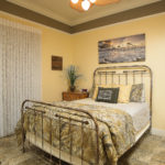 With a seashore feel to it, the guest bedroom opens out to the pool courtyard.