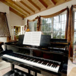 The music room has an antique wedding bed from Mali mounted on the wall. Wrought iron railings from the estate next door were restored and installed on the windows.