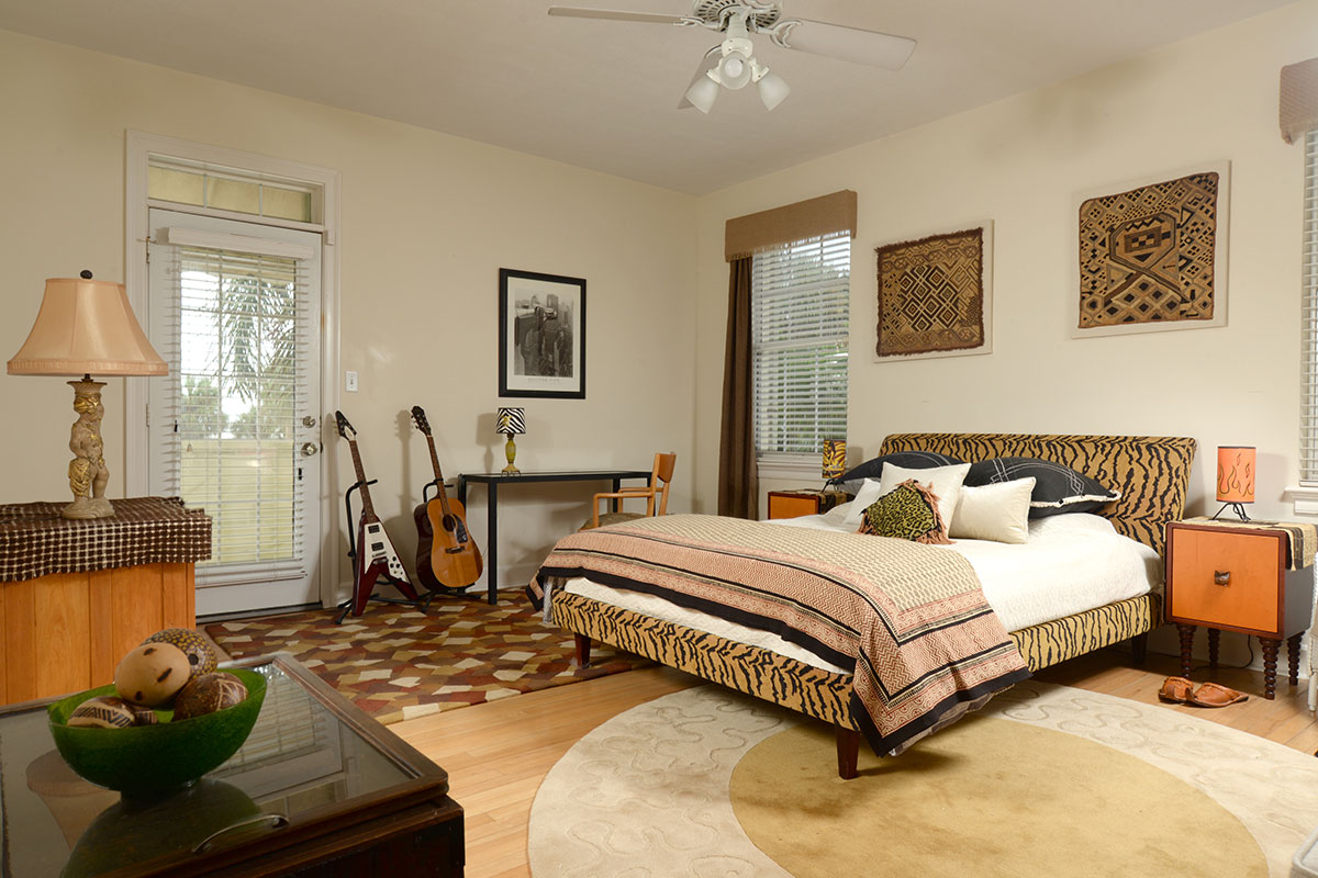 In the upstairs guest suite, two collectible African Kuba cloths made from raffia grass adorn the wall above the bed.