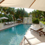 The pool area, featuring lush vegetation, a restored cabana and a barbecue grill, is perfect for gatherings.