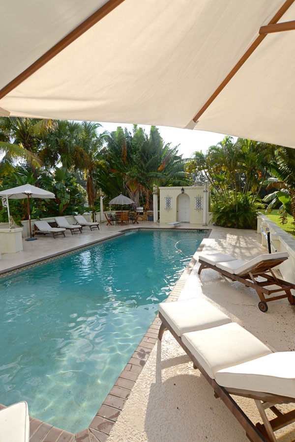 The pool area, featuring lush vegetation, a restored cabana and a barbecue grill, is perfect for gatherings.