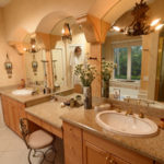 Refinished with Venetian plaster, the master bathroom features a spa tub, a shower and his-and-hers vanities.