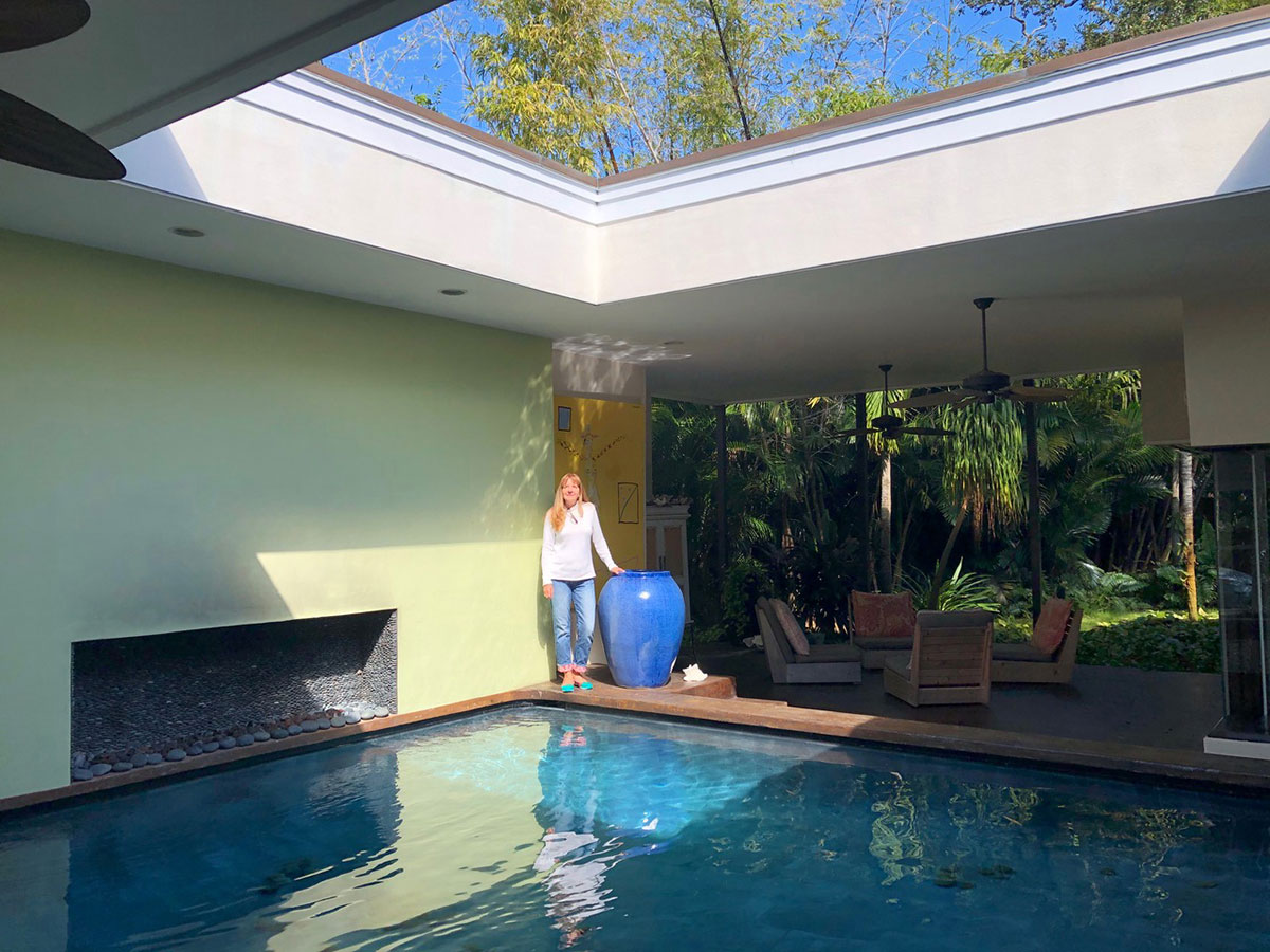 Holly Brennan stands by the pool at her Vero Beach home