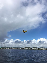 The big yellow plane flies above the Intracoastal Waterway