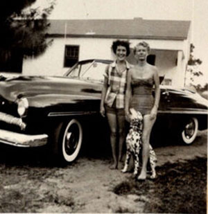 Katie, left, in front of the 1948 Mercury convertible