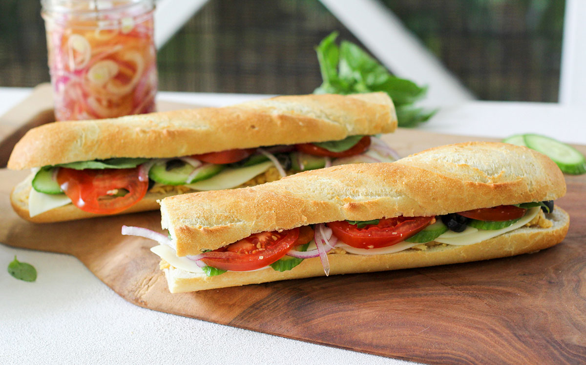 A hearty baguette filled with smashed chickpeas and veggies