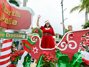 Ho, Ho, Ho, and Joy to the World from a giant jack-in-the-box on a float in the Stuart Christmas Parade hosted by the Visiting Nurse Association.