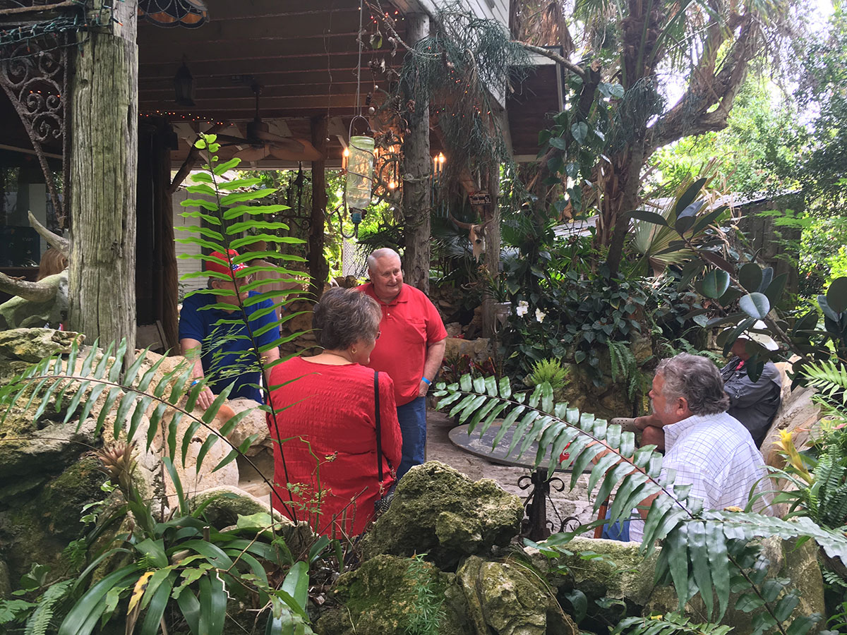 Mark Tripson, right, grandson of Waldo Sexton, regales visitors with stories of Waldo's secret garden and outdoor kitchen
