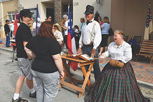 Historical re-enactors Talissa L. Wilson and James B. Odell talk with attendees at the 2017 Treasure Coast History Festival.