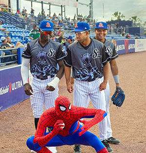 Spider-Man strikes a pose in front of Mets, from left, Carlos Dominguez, Rhylan Thomas and Dyron Campos. The players are sporting special Marvel Black Panther jerseys on Super Hero Night