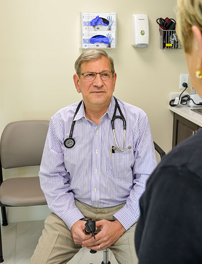 Dr. Hal Brown visiting with patient