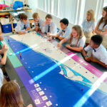 A group of middle school students is engaged in playing Lagoonology