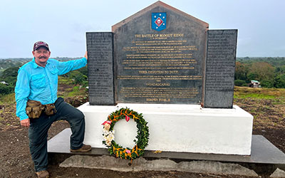 Beach stands near a memorial to the Battle of Bloody Ridge when Marines fought to repel Japanese attacks.