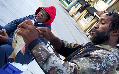 Veteran fisherman Moore looks on as his friend and fishing buddy, Lu Gene,