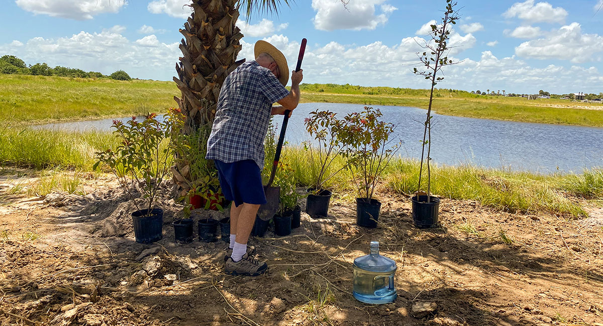 Volunteer Paul Sinnott plants native plants on the grounds of the center, a nine-acre expanse that used to be a citrus grove. An old 40-foot fire tower has been moved to the site. When it is reassembled, visitors will be able to climb it and see “old Florida” from above. 
