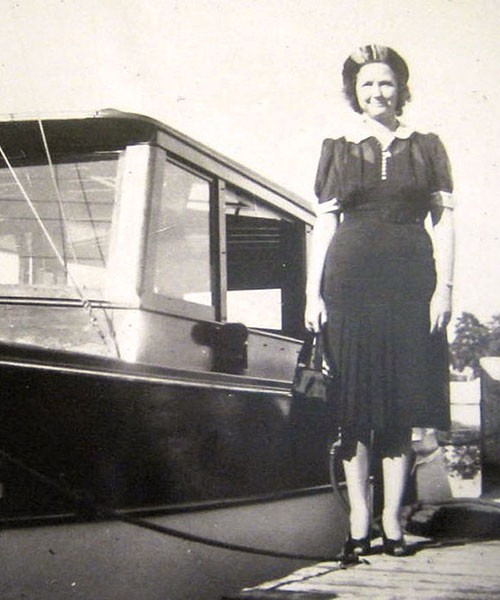 Laura Upthegrove stands in front of her cabin cruiser