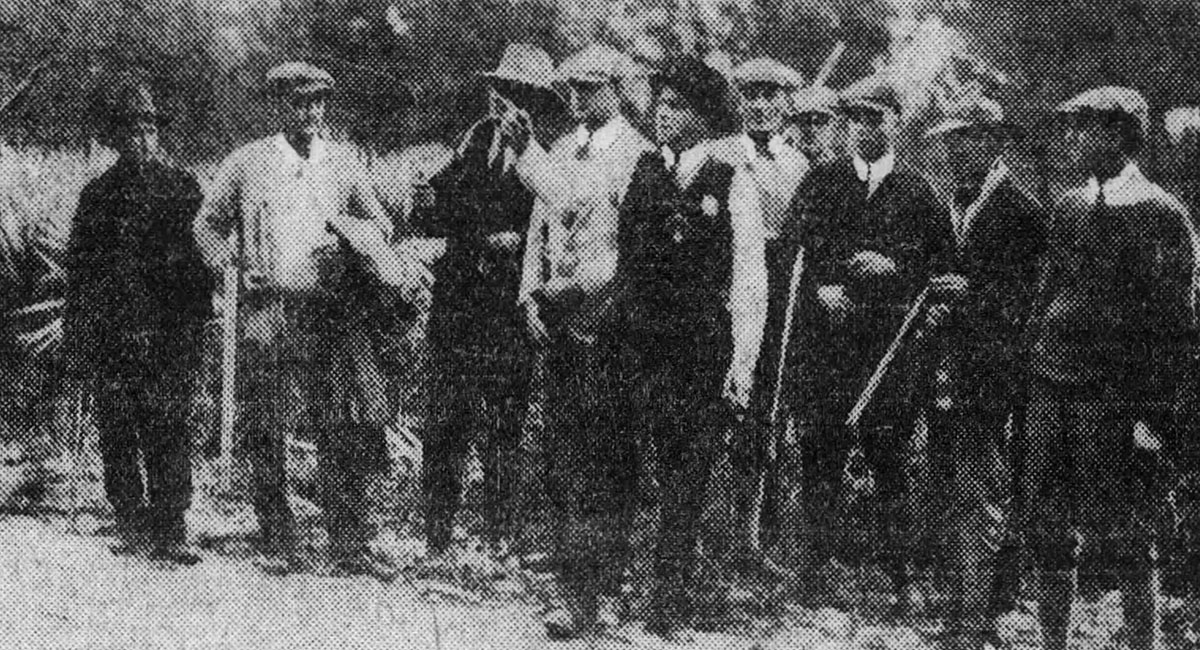 Sheriff Bob Baker gives directions to a posse looking for John Ashley.
