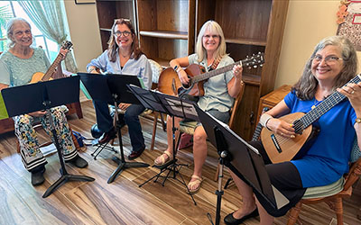 Blue Sky Strings, led by Joette Giorgis on the far right, is one of several musical groups that entertain visitors at Garden of Lights.