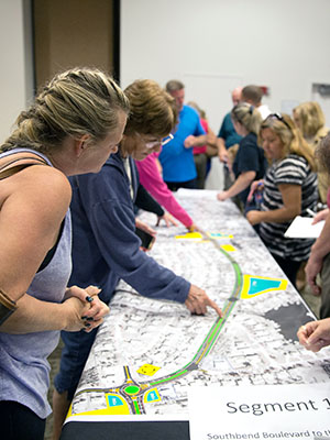 Residents are often invited to informational gatherings to look at new projects, ask questions, and offer their opinions. In this case they are looking at plans for improvements to Floresta Drive.