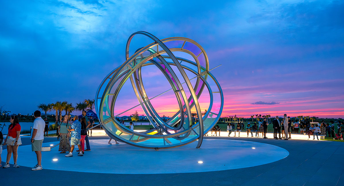 Rings depicting planetary orbits surround a sundial. Colored gels change as the sun moves.